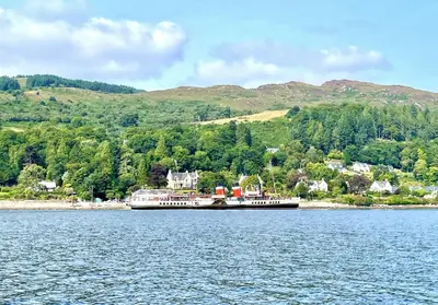 a large boat on a large body of water at The Lookout in Tighnabruaich