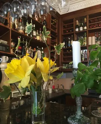 a vase with yellow flowers sitting on a table at Callander Meadows in Callander
