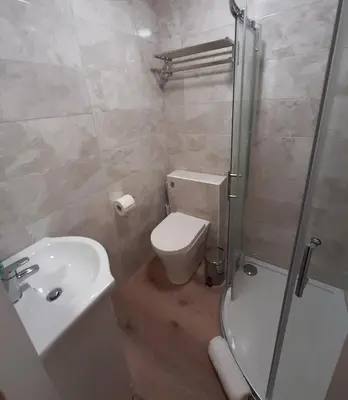 a bathroom with a toilet and a sink and a shower at Highlander House Boutique Hotel in Rothesay