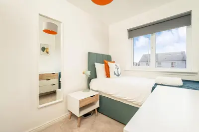 a bedroom with a bed and a window at Modern 3-Bed Family Home Near Glasgow Airport in Bishopton