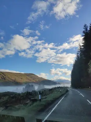 a road with fog on the side of the road at Craiglea Thistle in Killin
