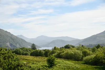 a view of a valley with mountains and a lake at Achanlochan Farm in Taynuilt