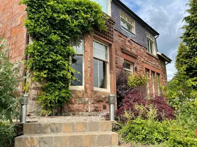 an old brick house with ivy growing on it at The Bield in Aberfoyle