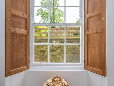 a window in a room with a basket in front of it at Superb 3Beds House in Chic area of the City Centre - Pass the Keys in Edinburgh