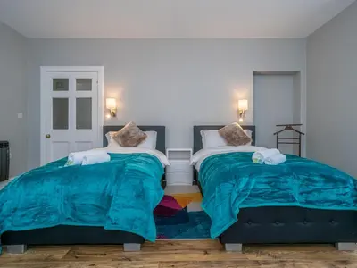 two beds sitting next to each other in a bedroom at Superb 3Beds House in Chic area of the City Centre - Pass the Keys in Edinburgh