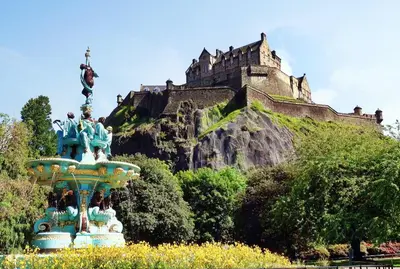 a statue in front of a castle on a hill at Superb 1 Bed Flat in Traditional Victorian Building - Pass the Keys in Edinburgh