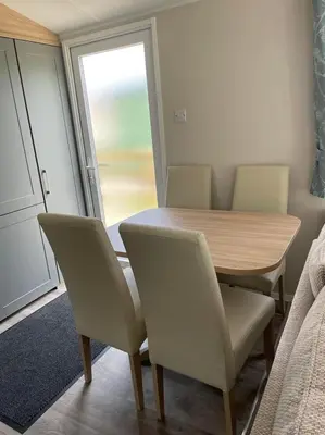 a table and chairs in a room with a window at Malton 74 in Dunoon