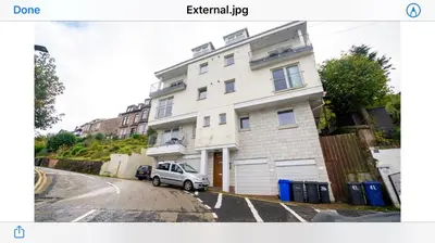 a white house with a car parked in front of it at Beautiful 3-Bed Apartment in Gourock in Gourock