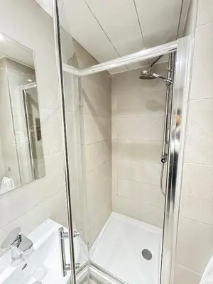 a bathroom with a shower and a sink at Sandyford Lodge in Glasgow