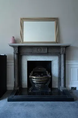 a fireplace with a mirror on top of it at Luxury Apartment/Flat Edinburgh City Centre in Edinburgh