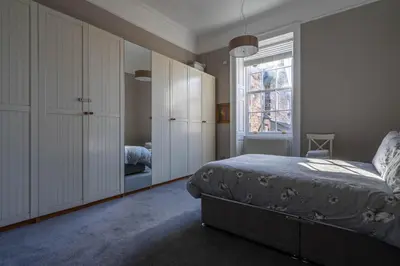 a bedroom with a bed and a window at Luxury Apartment/Flat Edinburgh City Centre in Edinburgh
