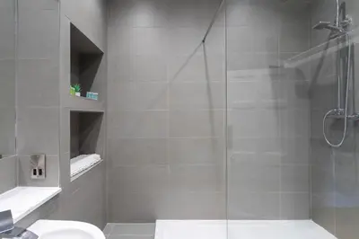 a bathroom with a shower with a glass door at Luxury Apartment/Flat Edinburgh City Centre in Edinburgh