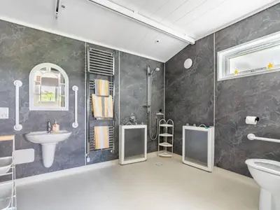 a bathroom with a shower toilet and a sink at Chalet Loch Leven Lodge 16 Robin's Nest by Interhome in Kinross