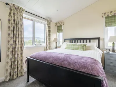 a bedroom with a bed and a window at Chalet Loch Leven Lodge 16 Robin's Nest by Interhome in Kinross