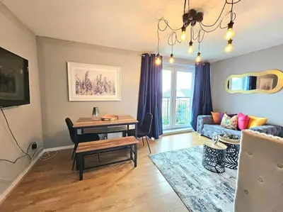 a living room with a table and a couch at 4 Separate Beds, Sleeps 6, Beautiful 2 bed Apt in Edinburgh