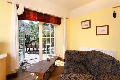 a living room with a couch and a table at Craigadam Lodge with Hot tub in Castle Douglas