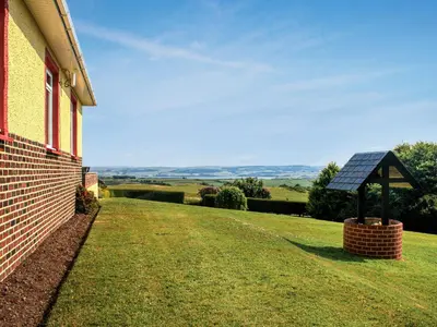 a house with a solar panel on the side of it at Cairncroft Cottage in Colfin
