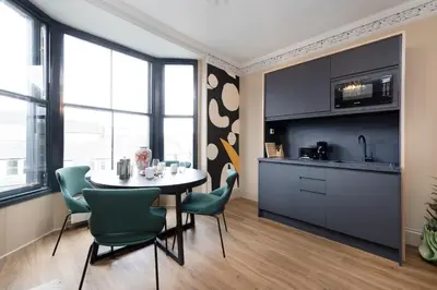 a kitchen and dining room with a table and chairs at 30 Castle Street Aparthotel in Edinburgh