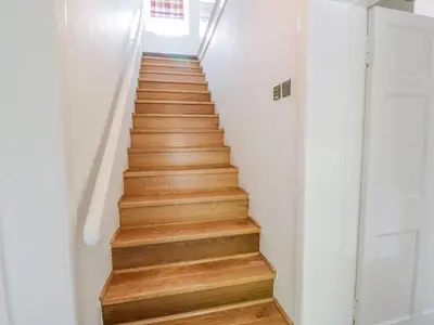 a staircase in a house with wooden floors at Garden House - Culzean Castle in Maybole