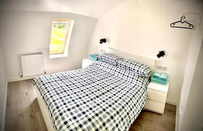 a bedroom with a bed with a checkered blanket at Glamping at Shieling Holidays Mull in Craignure