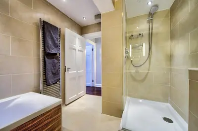 a bathroom with a tub and a shower and a sink at Gorgeous apartment in the heart of New Town in Edinburgh