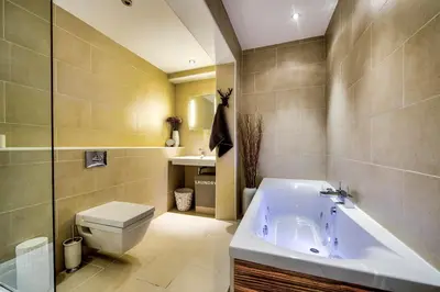 a bathroom with a tub and a toilet and a sink at Gorgeous apartment in the heart of New Town in Edinburgh