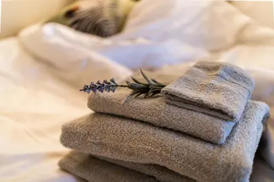 a pile of towels sitting on top of a bed at Huntly House - A Residence Like No Other in Glasgow