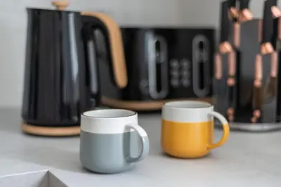 two coffee mugs sitting on top of a counter at Ground Floor 2 Bed Flat Slateford in Edinburgh