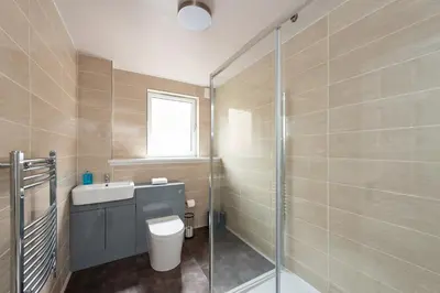 a bathroom with a toilet and a sink and a shower at Ground Floor 2 Bed Flat Slateford in Edinburgh
