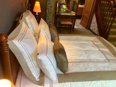 a bed with pillows on top of it at Havenwood in Ayr