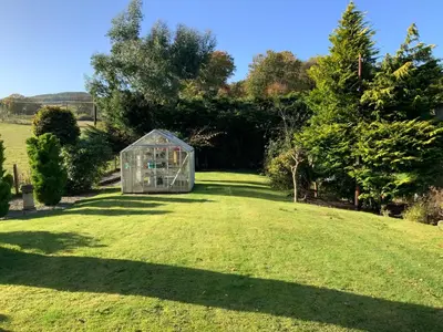 a greenhouse in the middle of a lawn at Havenwood in Ayr