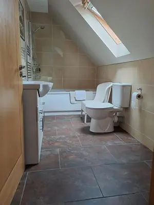 a bathroom with a toilet and a sink and a tub at B&B at No 4 in Biggar