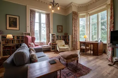 a living room with a couch and a table at Achnacloich in Achnacloich