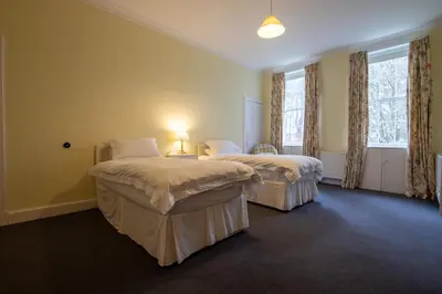 two beds in a room with two windows at Achnacloich in Achnacloich