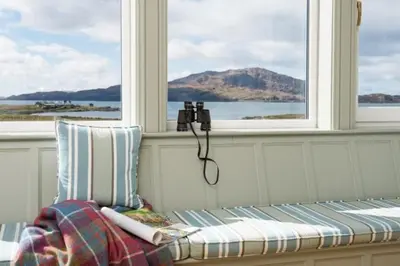 a room with a bench in front of two windows at Ardlarach Lodge in Cullipool