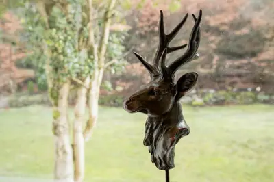a statue of a deer with antlers on a pole at Ardchyle House in Killin