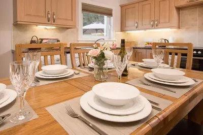 a dining room table with plates and glasses on it at Ardchyle House in Killin