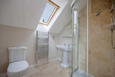 a bathroom with a toilet and a sink and a shower at Branter Lodge in Strachur