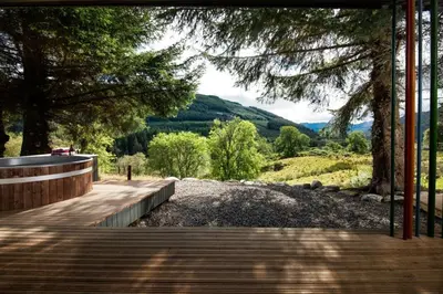 a wooden walkway with a view of a mountain at Am Bothan in Lochearnhead