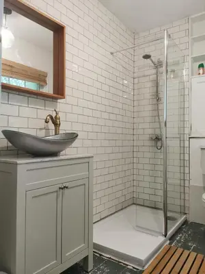 a bathroom with a sink and a glass shower at Arrochar Fern Cottage with Wood Burner & Loch View in Arrochar