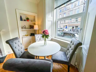 a dining room with a table and two chairs and a window at Desirable 2 Bed Apt Near Edinburgh Castle in Edinburgh