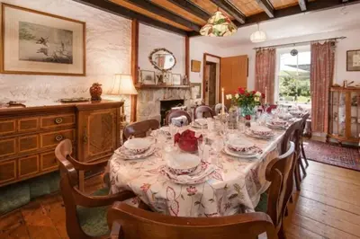 a large dining room with a long table with chairs at Strone House in Helensburgh