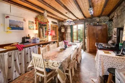 a dining room with a long table and chairs at Strone House in Helensburgh