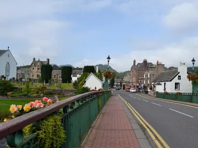 a bridge over a street in a small town at Arden House in Comrie