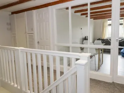 a white staircase in a living room with white railings at Waters Edge in Stranraer