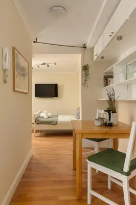 a living room with a table and a couch at Dean Village Hideaway by Calton Living in Edinburgh