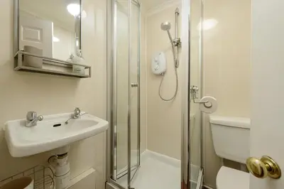 a bathroom with a sink and a shower at Dean Village Hideaway by Calton Living in Edinburgh