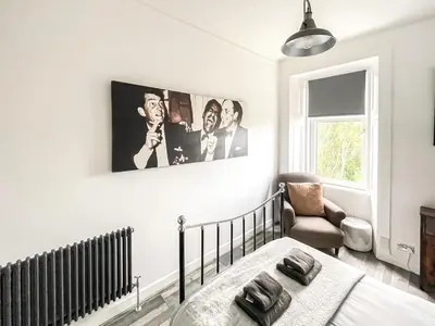 a bedroom with a bed and a picture on the wall at Osborne Place in Rothesay