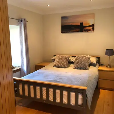 a bedroom with a bed with two pillows on it at Old Tynribbie House - Comfortable Detached House in Appin