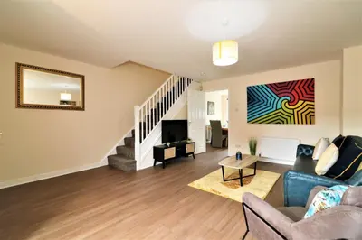 a living room with a couch and a tv at Signature - Harris House in Glasgow